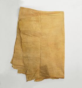 Barkcloth 'ahu A piece of thin barkcloth dyed a yellow-brownish colour that also exhibits some reddish and greyish discolouration. Used as a cloak-like cape.