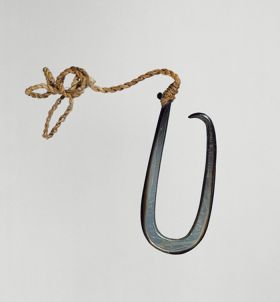 Fishhook matau Fishhook made of a large dark purple pinna shell where strings made of various plant fibres are attached.