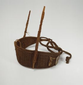 Headband Headband made of grass and sticks wrapped with fibres attached on either side of the headband which protrudes 11cm above the headband.