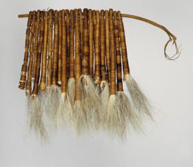 Tassels of hair Tufts of dog hair bundled together into twenty-two tassels and tightly wrapped both length-wise and crosswise with fine coconut fibre threads and threaded onto a stick.