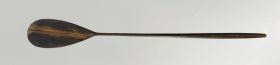 Oz 440 Tattooing mallet made from a piece of brown wood. Its long rounded handle thickens at the holding end and tapers towards the slightly concave striking surface
