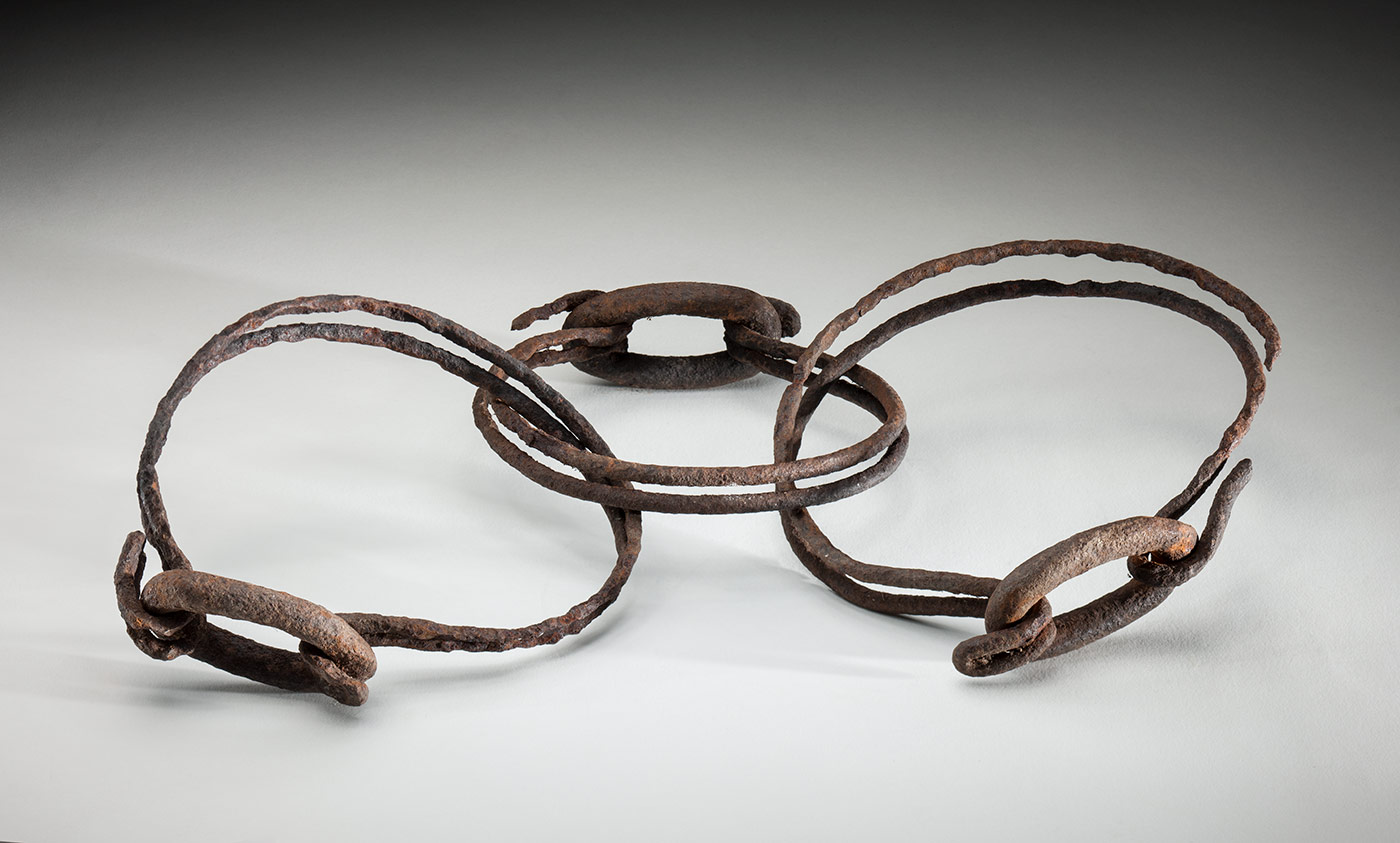 Two larger rusted wire rings joined by a smaller, central ring.