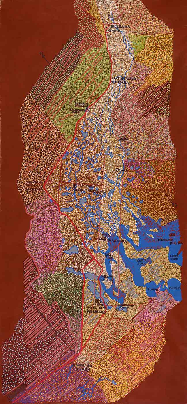 A long rectangular dot painting on canvas showing a topographical map of a region with a lake or river system which starts at the lower right side and moves up the centre to the top. There is a red wavy line and pink-brown lines like tracks or roads on the painting. The sections in the painting are dotted with different colour combinations including lime green and green, pink and green, beige and black, yellow and orange, blue, yellow and orange, black, grey and brown, pink and purple and others.