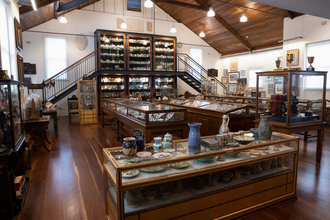 Colour photograph of a display room featuring a large collection of objects including crockery, trophies, artworks and other memorabilia.