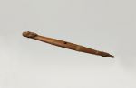 Flute putorino Flute made of wood with two halves mounted together. A carving at the lower closed end and the upper open end is a human head with mother-of-pearl eyes and an extended tongue.