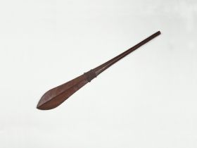 169.jpg Club made of brown wood that is slightly rhomboid shaped at one end and paddle-shaped at the other. Both ends separated by a pair of bulged rings framing a section of engraving.