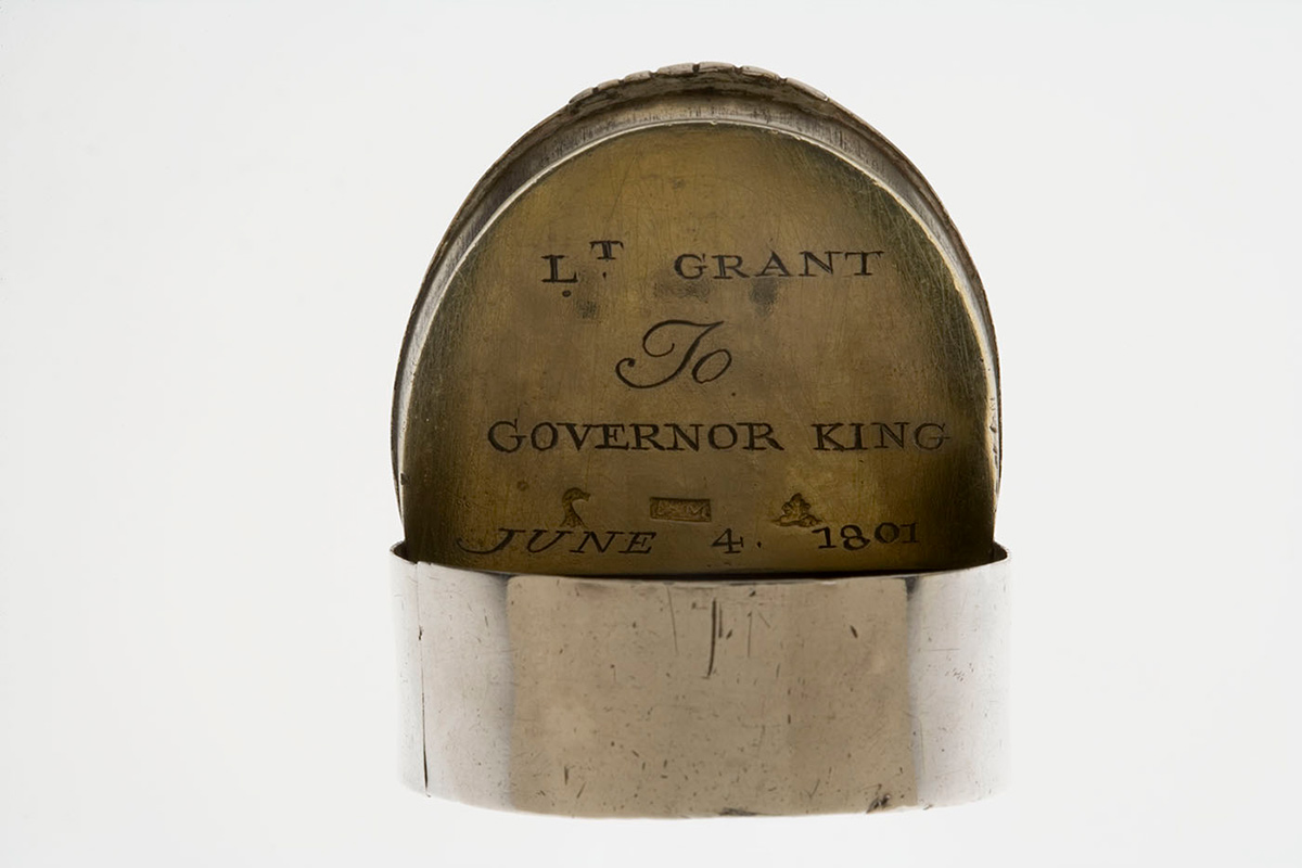 Silver snuff box with lid open to reveal engraved inscription.