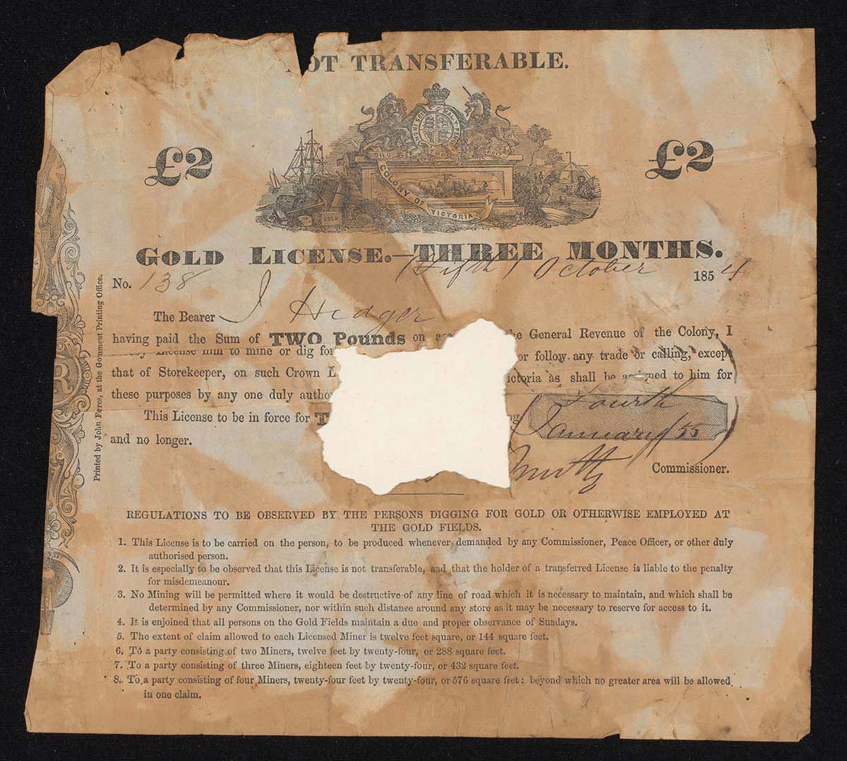 Photograph of a 'GOLD LICENSE' printed on paper, which has been folded and torn around the edges and has a section missing at the centre. A 'Colony of Victoria' coat of arms is centre top, wth text underneath.