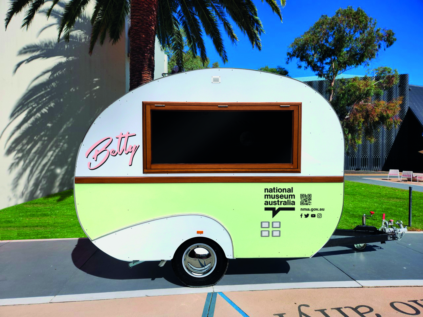 Betty the Museums caravan. The caravan is retro and painted a soft pink and green. 