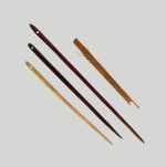 Netting needles hui, netting needle hui kupenga Oz 200, 201, 203, 204 Long wooden needles made of dark brown wood and pointed at the ends with an eye at the wider end.