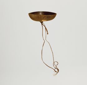 109.jpg Drinking bowl made from a dark brown, ripe coconut with a triangular-shape opening.