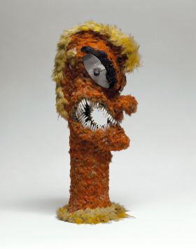 313.jpg Feathered idol with the shape of a human figure, formed of wicker-work, overlaid with feathers of red, yellow and black. The eyes are mother-of-pearl and the mouth fitted with dog-teeth.