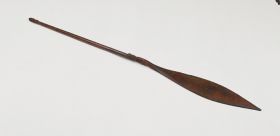 226.jpg Wooden paddle of a war canoe. The shaft is decorated with ornaments at the handle and at the connection of the blade.