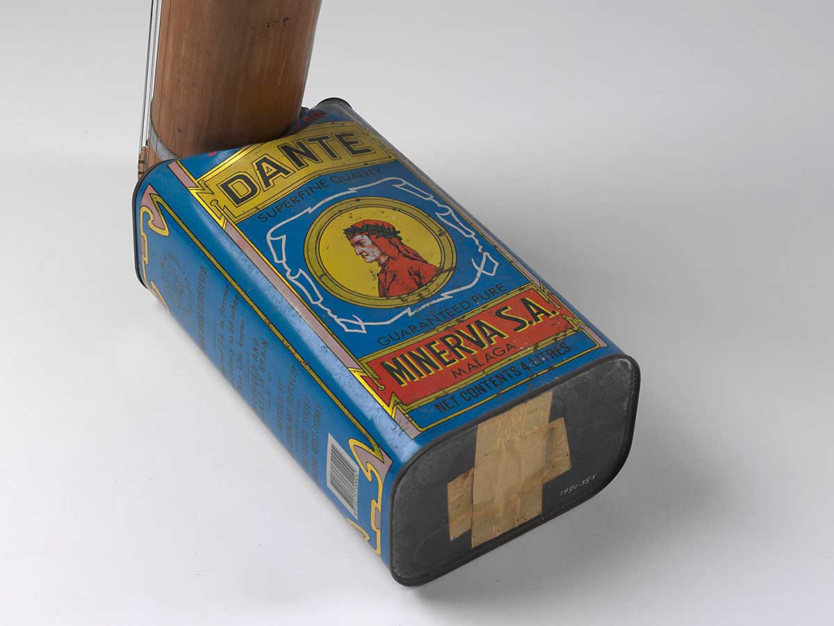 A blue tin with 'DANTE' written at the top and 'MINERVA SA' at the base. An image of a man dressed in red appears in a central circle on the tin. Bamboo tubing extends from one end.