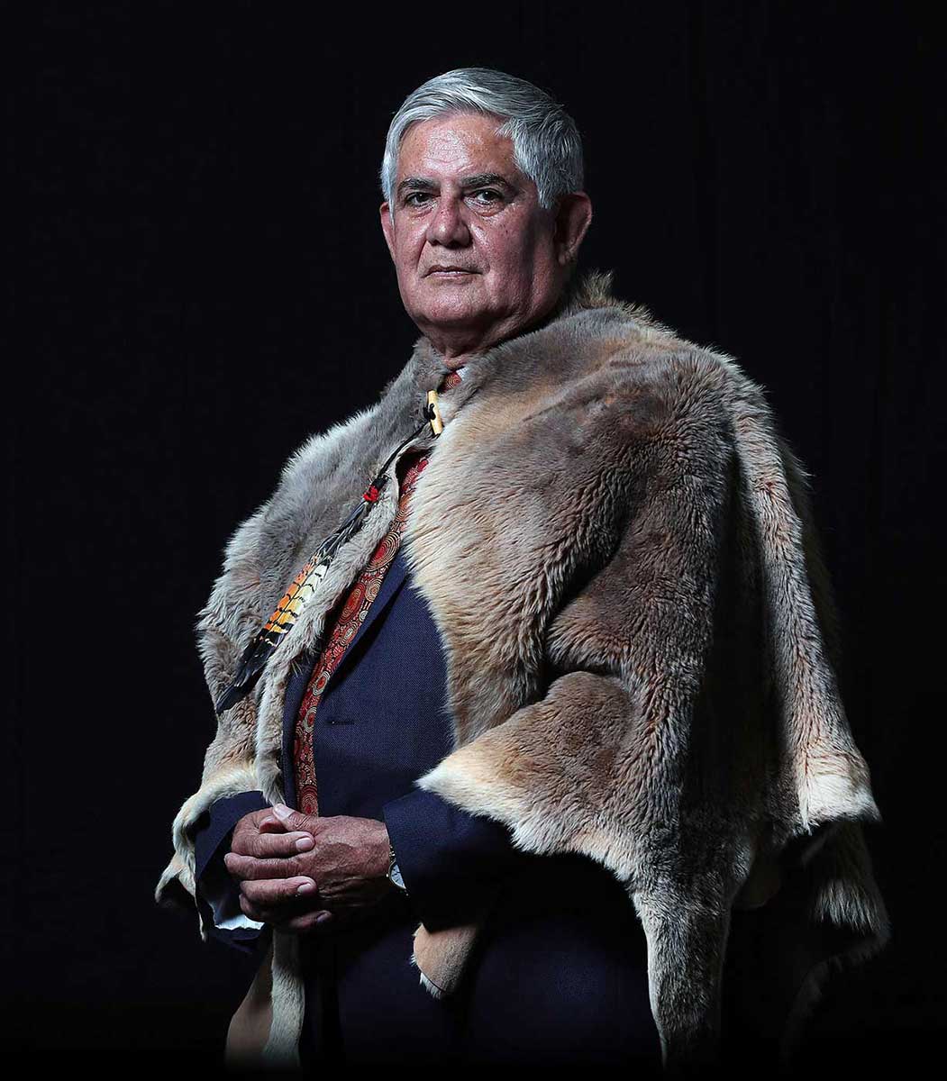 A portrait of a man wearing a possum pelt over a blue suit.