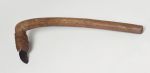 Adzes toki Small stone adzes with round handle and knee made of a light brown, lightweight wood with a four edged blade made of basalt, firmly attached to the shaft with plaited coconut fibres.