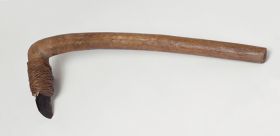 Adzes toki Small stone adzes with round handle and knee made of a light brown, lightweight wood with a four edged blade made of basalt, firmly attached to the shaft with plaited coconut fibres.