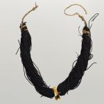 Breast ornament with hook lei niho palaoa Breast ornament with hook. Hung from two black bundles of twisted human hair, connected by a cord. A pendant at the front is made of whale tooth and has the form of a hook.