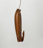 Fishhook ipa or aipa Fishhook with wood shank backed with mother-of-pearl and tied together. A barbed Tortoiseshell hook also attached to the end.