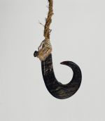 Fishhook matau Fishhook made of a large dark purple pinna shell where strings made of various plant fibres are attached.