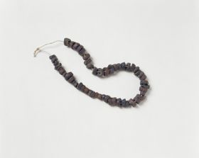 39.jpg Jewellery & Adornment made from black-brown coconut discs arranged on a string.