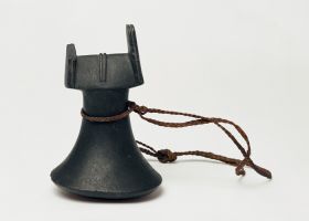 Pounder penu Pounder made from a single piece of black basalt with polished finish. A string binding at the neck is plaited from plant fibres. The object has a pounding surface, neck and a head part.