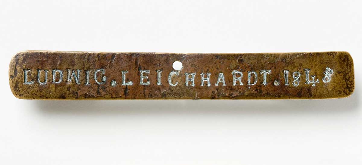 Front view of the Leichhardt nameplate which is a piece of brass 15 cm x 2 cm marked LUDWIG. LEICHHARDT. 1848