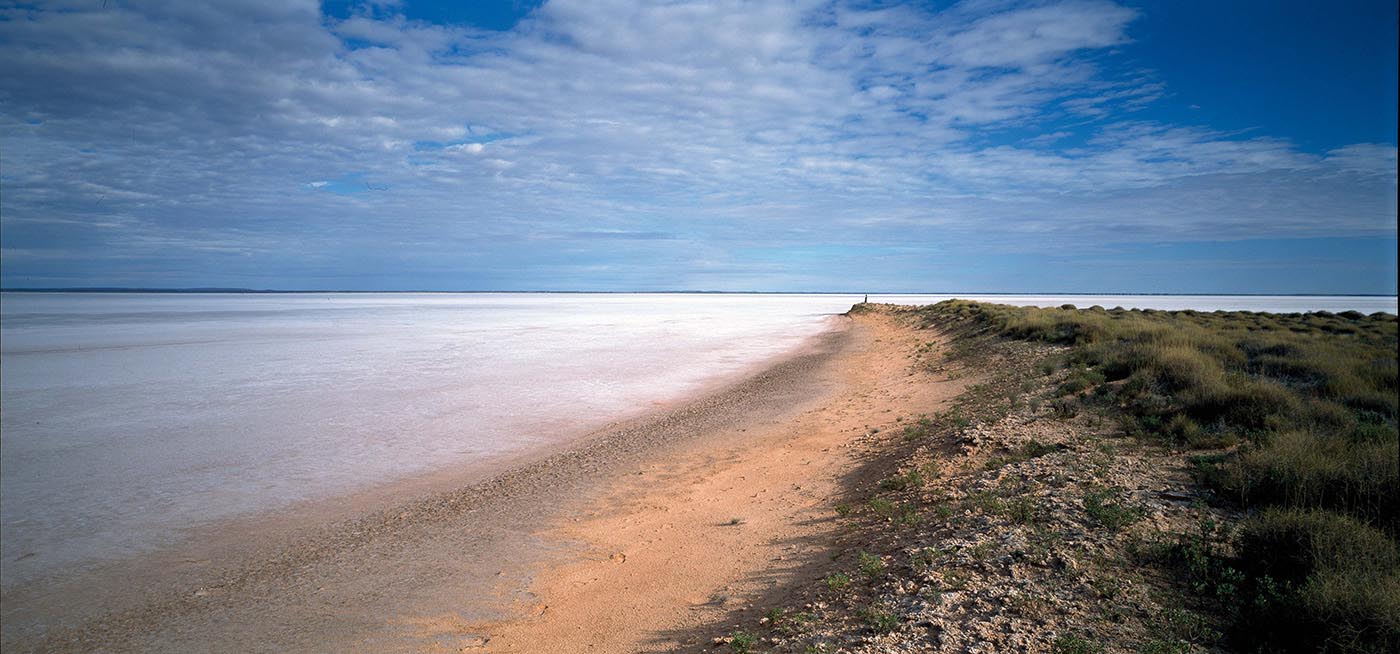 Colour photo of a landscape featuring a vast dried lake bed.