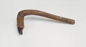 Adzes toki Stone adzes, with a round handle and knee made of a light brown lightweight wood with a four edged blade made of basalt, and attached to shaft with plaited coconut fibres.