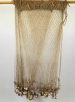 Fishing net upea Large fishing net of whitish parau with numerous weights of white coral tied with strands of plaited coconut fibre along the lower long sides, and floats of small parau sticks along the upper long sides.