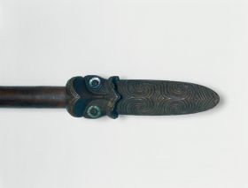 165.jpg Club made of heavy brown wood, the grip end decorated with line and facial ornaments, the eyes inlaid with mother-of -pearl shell.