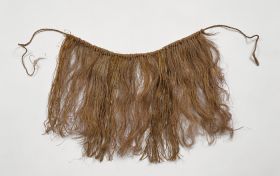 Skirt Skirt or apron made from fine shred of plantain leaf, dyed and knotted to a string that fastens around the waist.