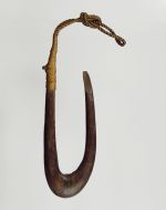 203.jpg Fishhook made of a finely polished piece of hardwood. The point of the hook is flat on the side and the upper end of the shank is supported and secured with plaited coconut fibres.
