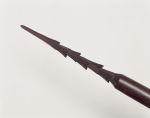 184_a.jpg Spear made of brown wood and polished. The point is 24cm long with six rows of three barbs each.