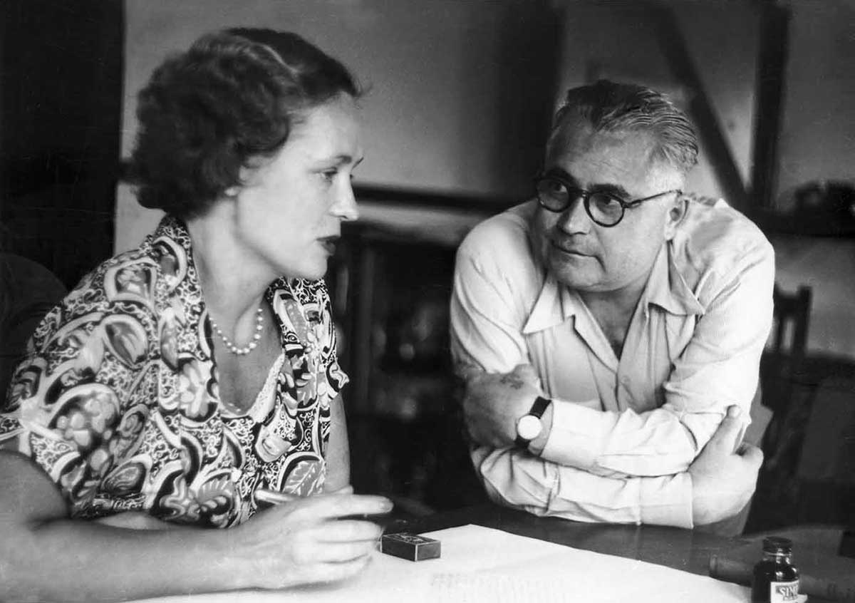 Man and woman talking at a table.