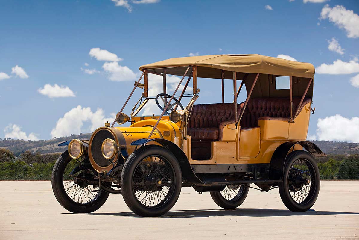 An automobile featuring a yellow body, black mudguards and running boards.