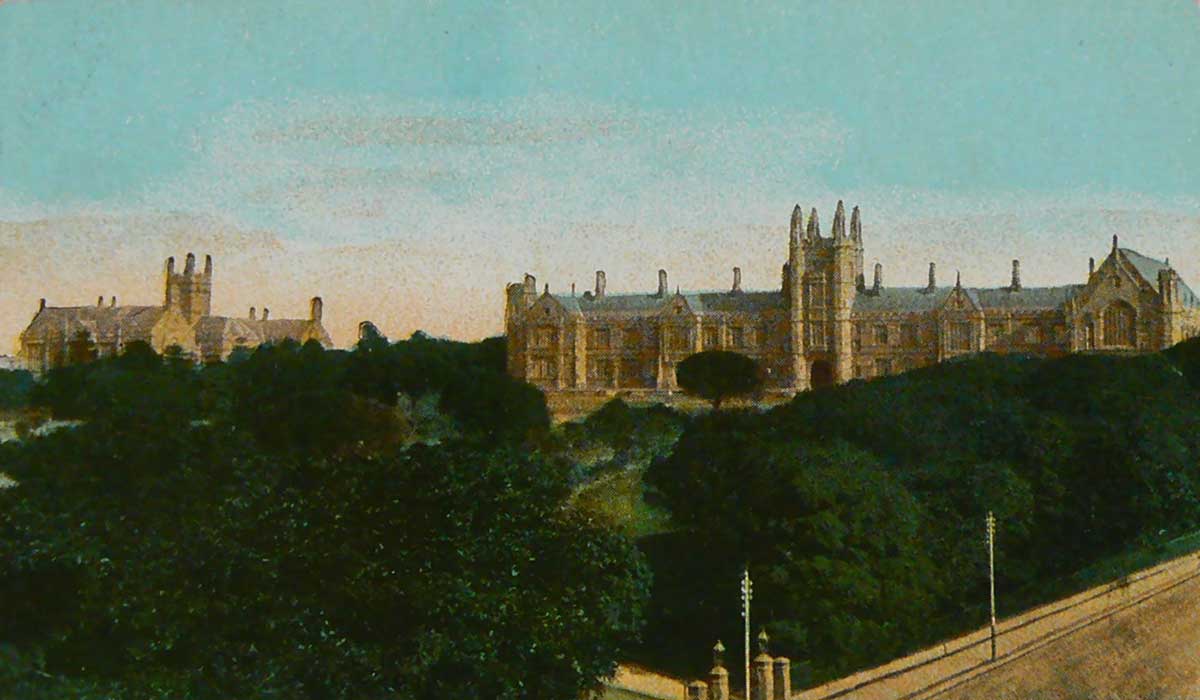 An unused postcard featuring a colour image of buildings at the University of Sydney with gardens in the foreground.