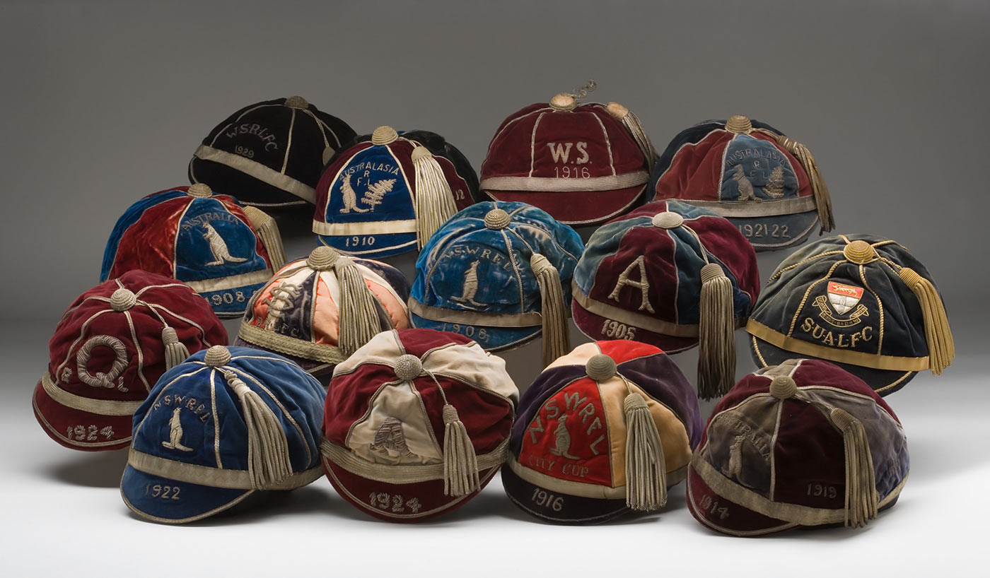 An assortment of early rugby league caps, in various team colours.