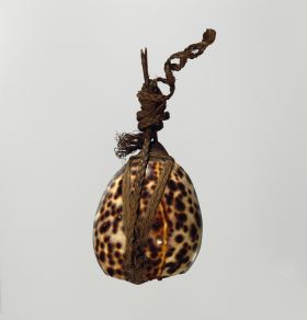 Lure maka feke Lure that consists of a brownish, cone-shaped piece of stalactite, securely fastened to a large leopard cowry shell, a twig for a tail all tied together with braided coconut fibres.