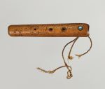 Flute koauau Flute made of light brown wood, embellished with spiral patterns in dots and lines, with a mother-of-pearl plate and three holes, at one end with the remains of a twisted cord.