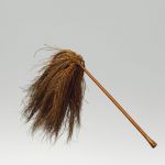 Flywhisk fue kafa A fly-flap or whisk, made of coconut fibres, affixed to a wooden handle of reddish–brown colour, polished and bulged at both ends and a tassel of blackish-brown coconut fibres.