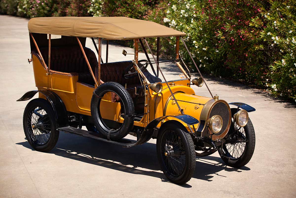 An automobile featuring a yellow body, black mudguards and running boards.