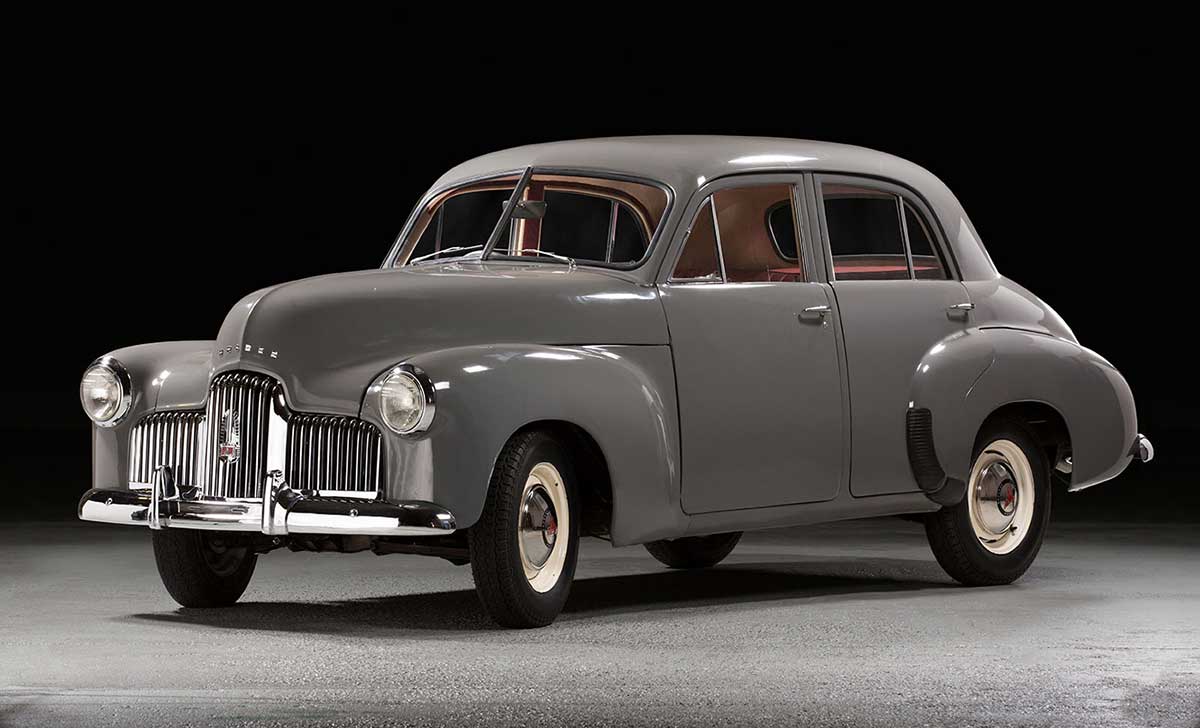 Antique grey car being displayed.