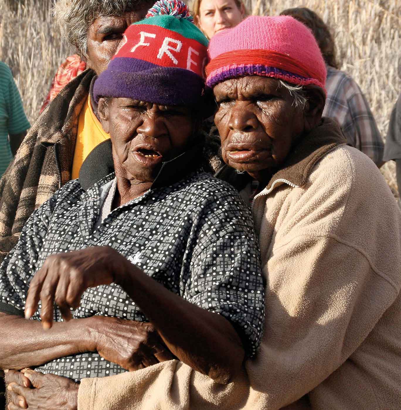 Two elderly women embracing.