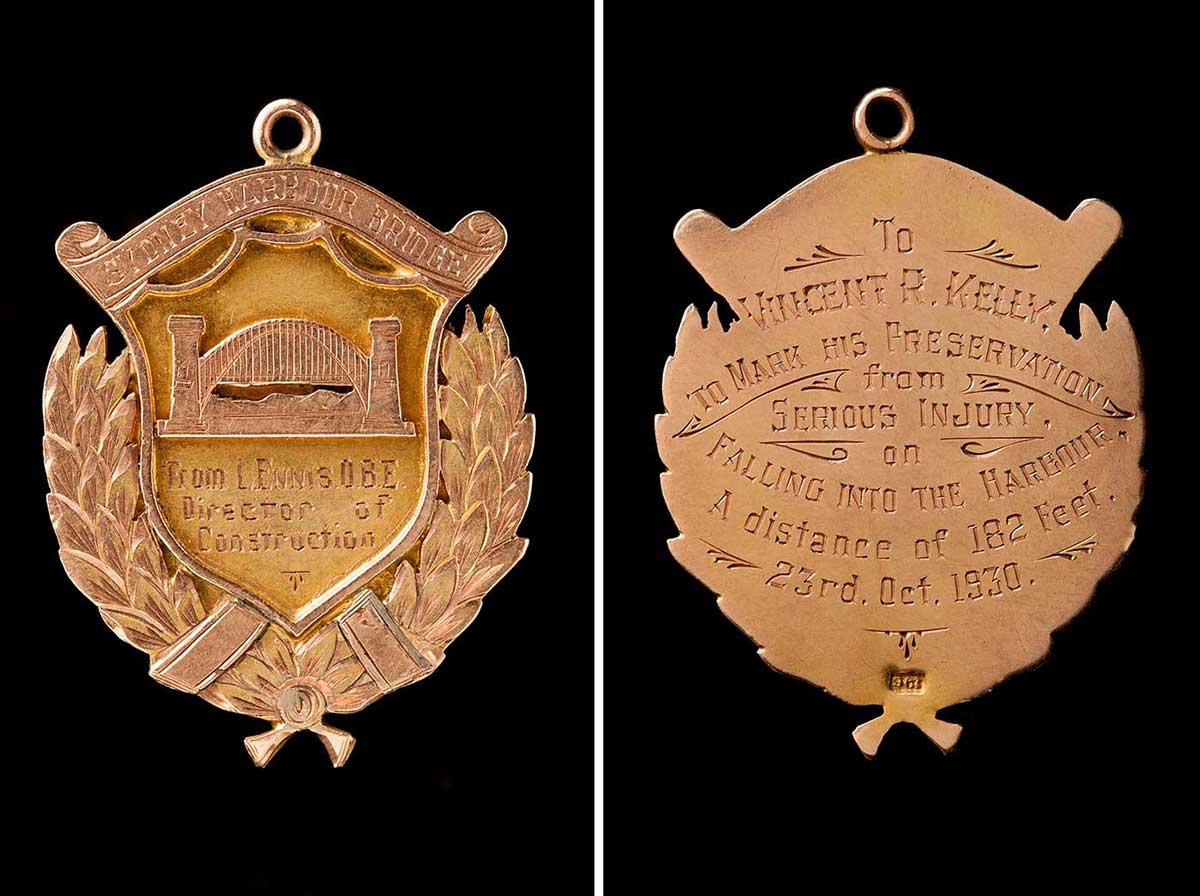 The front and back of a medal awarded to Vince Kelly. The front has an image of the Sydney Harbour Bridge with an inscription that reads: 'From L. Ennis. O.B.E. Director of Construction'. The inscription on the back reads: 'To Vincent R. Kelly. To mark his preservation from serious injury on falling into the harbour. A distance of 182 feet. 23rd. Oct. 1930.'