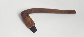 Adzes toki adzes, with a round handle and knee made of a light brown, lightweight wood with a four edged blade made of basalt, and firmly attached to the shaft with plaited coconut fibres