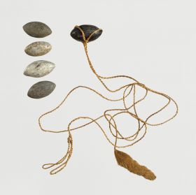 Sling and sling stones Sling made of two twisted plant fibre strings about 2mm thick with a tufted end. The sling stones, from steatite, have the shape of a symmetrical egg.