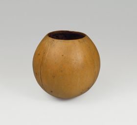 107.jpg Drinking bowl made from white coconut where the shell was split open just above its widest point.