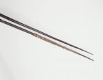 186_b.jpg Wooden spears that are thin at the lower end and gradually thicken to an engraved pattern. One spear is bound near the point with bark cloth.