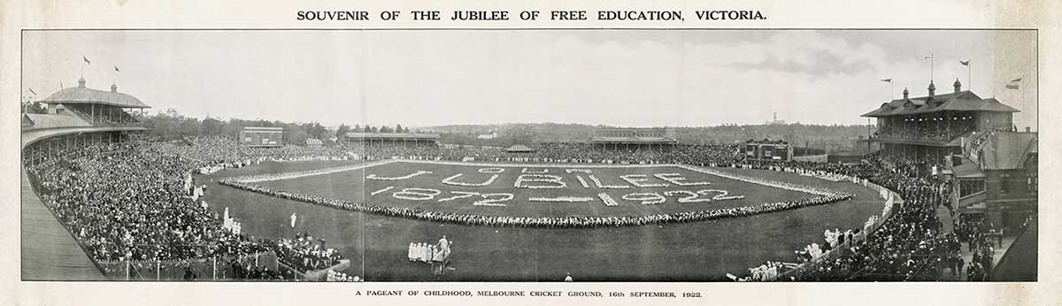Panoramic black and white photograph of a large oval, possibly the MCG, with crowded stands. The words ‘Jubilee 1872 – 1922’ appear on the oval itself.
